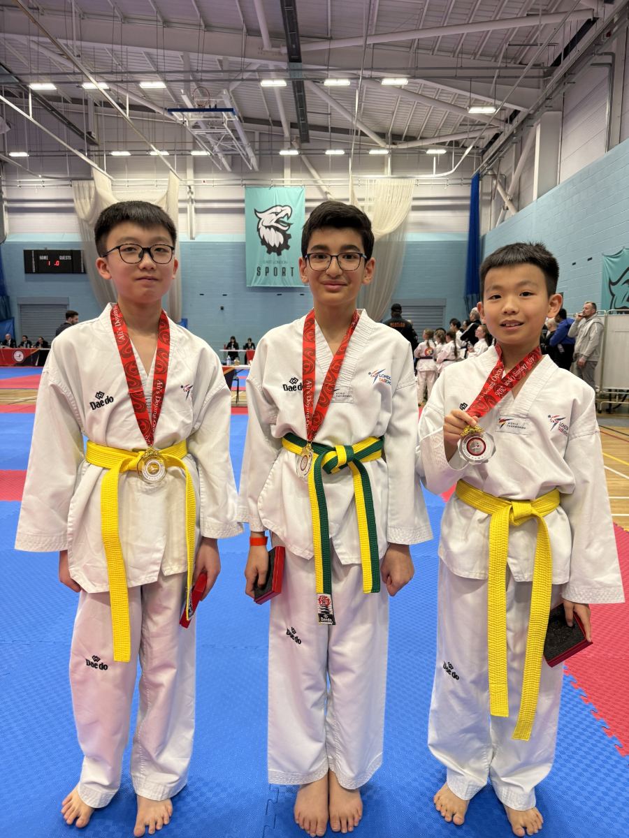 Three students wearing medals