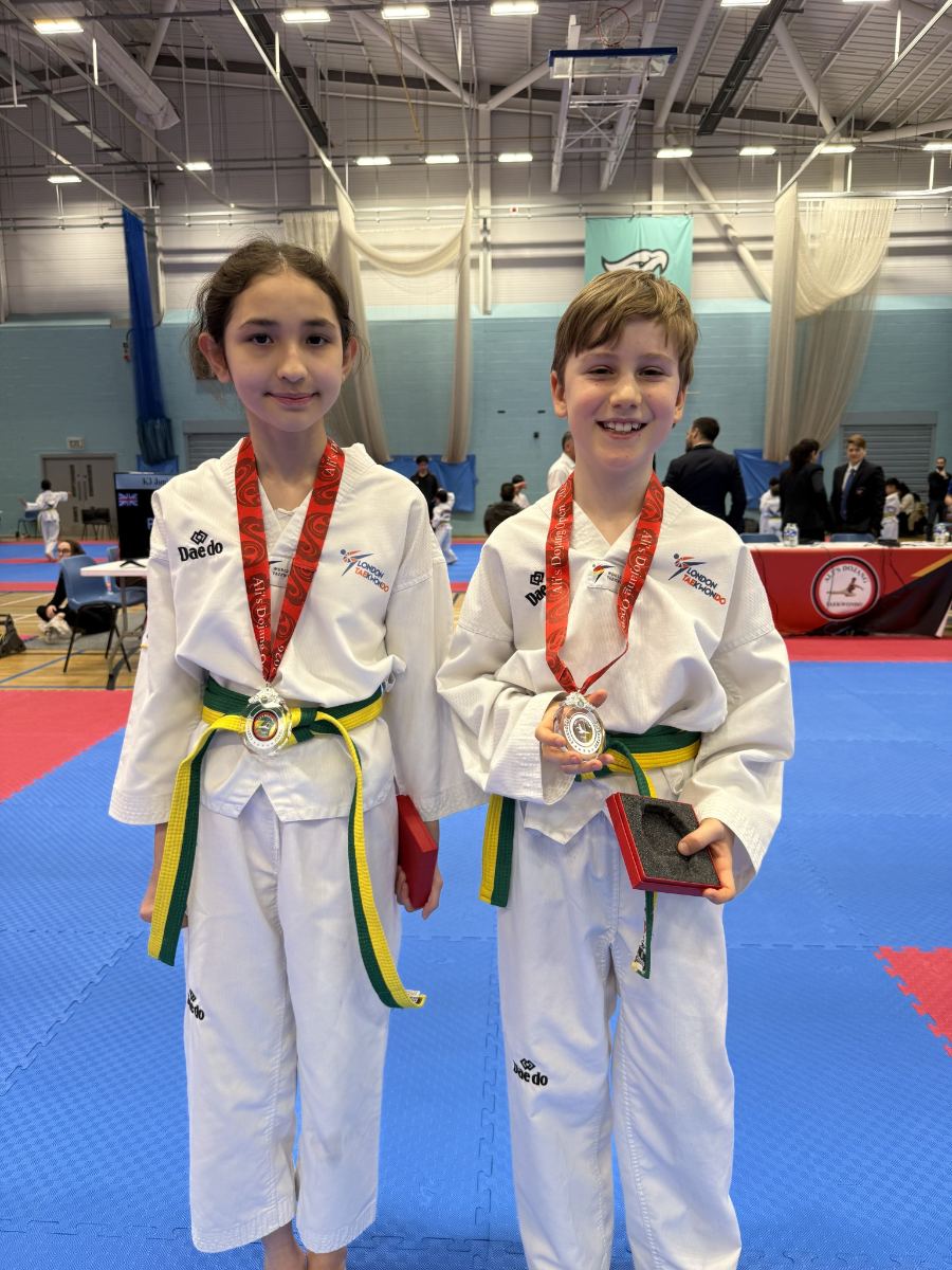Two students wearing silver medals