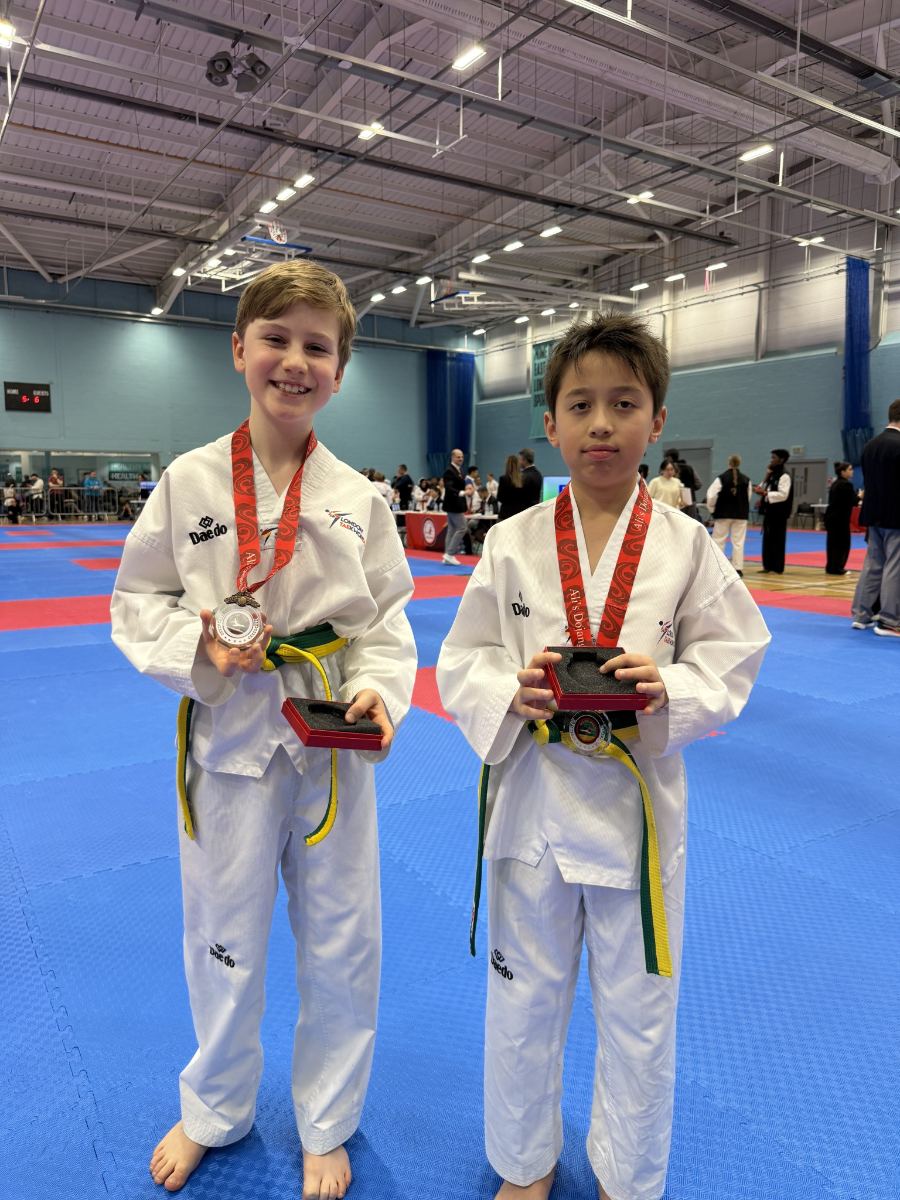 Two students holding their medals