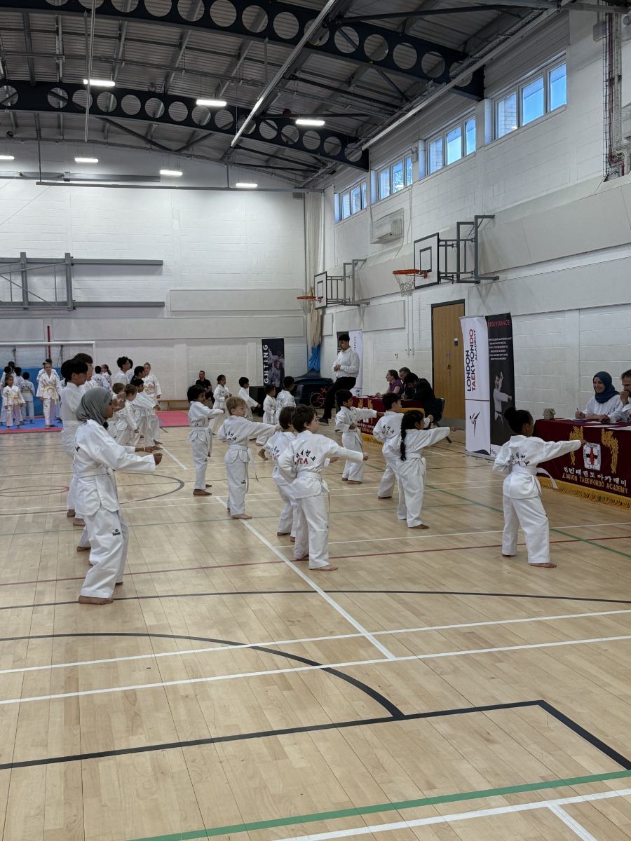 White belt students performing punches together at a grading