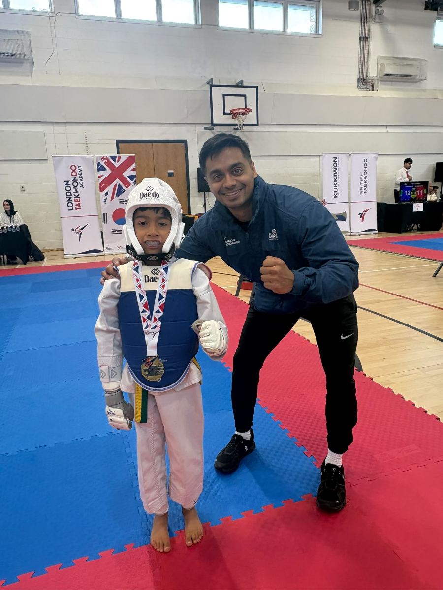 Young student in blue body guard with a gold medal